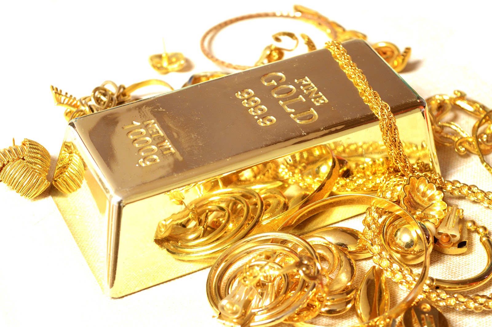 A Fine Gold Bar Surrounded By Compliamenting Jewelry